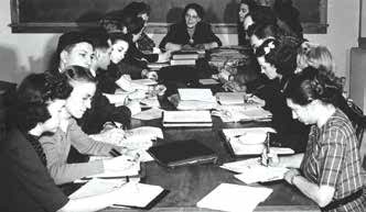 Students reading and writing at a table